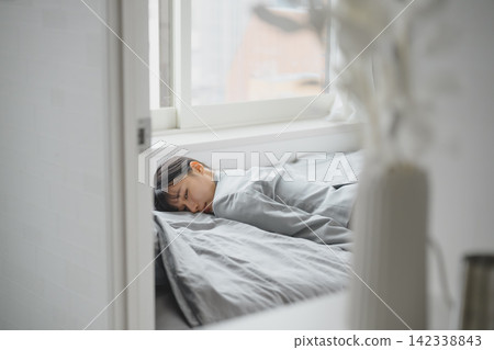 The exhaustion of a businesswoman, lying in bed. The exhaustion of a businesswoman, lying in bed. 142338843