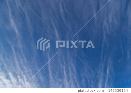 Wispy Cirrus Clouds Streaking Across a Clear Blue Sky Wispy Cirrus Clouds Streaking Across a Clear Blue Sky 142339124