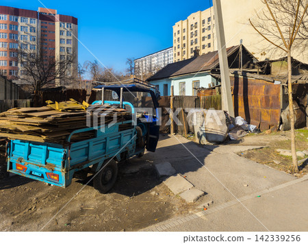 Blue Three-Wheeled Utility Vehicle with Cardboard Boxes in Kyrgyzstan Blue Three-Wheeled Utility Vehicle with Cardboard Boxes in Kyrgyzstan 142339256