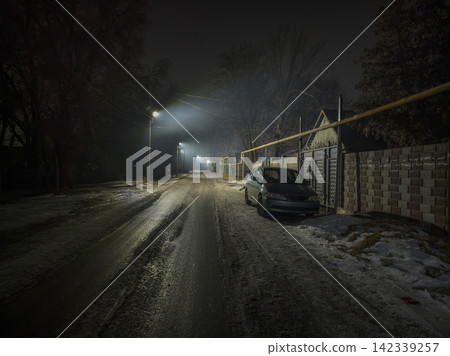 Dark Foggy Night on Residential Street with Minivan Dark Foggy Night on Residential Street with Minivan 142339257