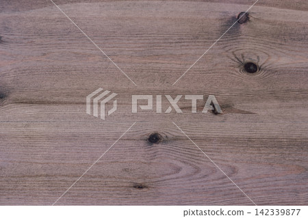 Close-up image of a wooden surface displaying distinct knots and grain patterns, emphasizing a rustic texture ideal for backgrounds, furniture design, or interior decoration projects Close-up image of a wooden surface displaying distinct knots and grain patterns, emphasizing a rustic texture ideal for backgrounds, furniture design, or interior decoration projects 142339877