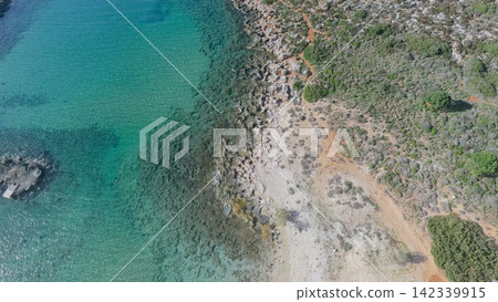 Aerial top view of rocky Mediterranean coastline with green shrubs turquoise bay and clear sea water on Crete island Greece horizontal stock photo Aerial top view of rocky Mediterranean coastline with green shrubs turquoise bay and clear sea water on Crete island Greece horizontal stock photo 142339915