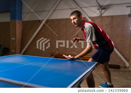 Male table tennis player preparing to serve the ball Male table tennis player preparing to serve the ball 142339968