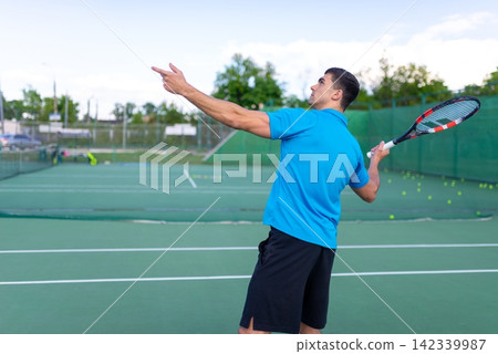 Tennis player pointing up during an outdoor match Tennis player pointing up during an outdoor match 142339987