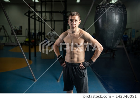 Athlete standing with hands on hips after boxing training Athlete standing with hands on hips after boxing training 142340051