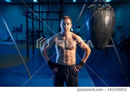 Athlete standing with hands on hips after boxing training Athlete standing with hands on hips after boxing training 142340052