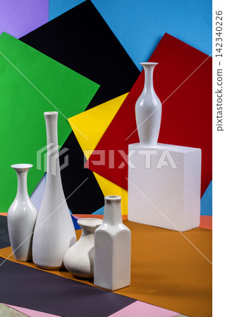 Indoor flowers and white vases on an abstract background Indoor flowers and white vases on an abstract background 142340226