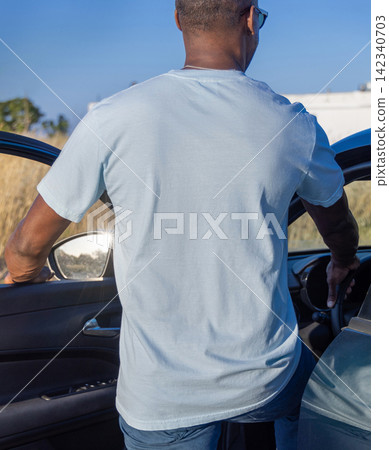 Blank light blue oversized t-shirt mockup on Black man outdoors, back view with copy space Blank light blue oversized t-shirt mockup on Black man outdoors, back view with copy space 142340703