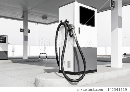 Modern gas station pump with hose and nozzle in black and white Modern gas station pump with hose and nozzle in black and white 142341319