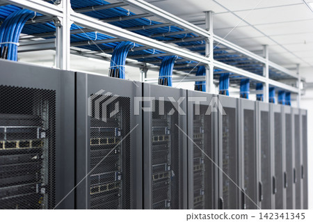 Modern data center with rows of server racks and organized blue network cables Modern data center with rows of server racks and organized blue network cables 142341345