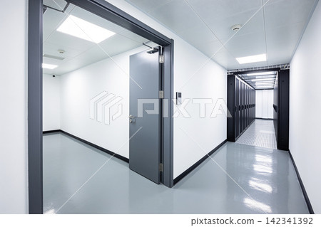 Modern server room hallway with open door and rows of data cabinets Modern server room hallway with open door and rows of data cabinets 142341392