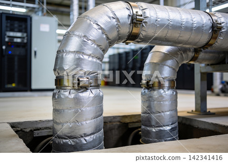 Insulated industrial pipes curving through a modern data center environment Insulated industrial pipes curving through a modern data center environment 142341416