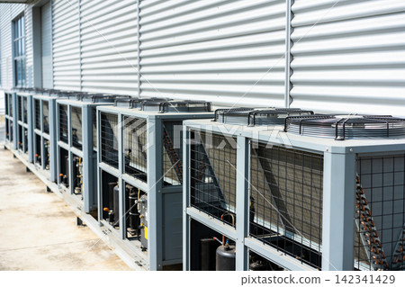 Row of industrial air conditioning units installed outside a building Row of industrial air conditioning units installed outside a building 142341429