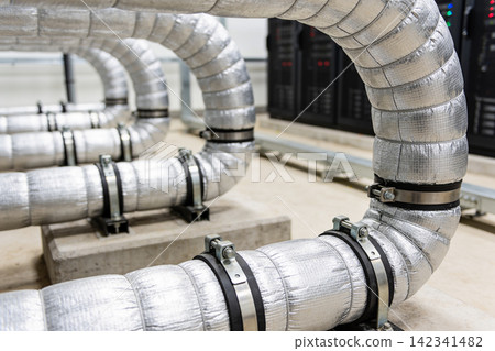 Industrial insulated pipes with metal clamps in a data center environment Industrial insulated pipes with metal clamps in a data center environment 142341482