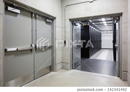 Modern server room entrance with double emergency exit doors and rows of data cabinets Modern server room entrance with double emergency exit doors and rows of data cabinets 142341492