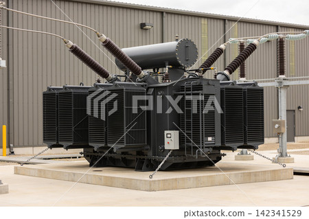 Large industrial power transformer with cooling fins and electrical insulators Large industrial power transformer with cooling fins and electrical insulators 142341529