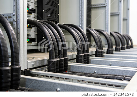 Industrial power cables neatly organized in a data center or server room Industrial power cables neatly organized in a data center or server room 142341578