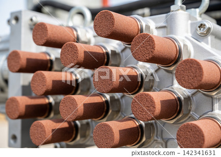 Close-up of industrial hydraulic pump manifold with multiple bronze silencers Close-up of industrial hydraulic pump manifold with multiple bronze silencers 142341631