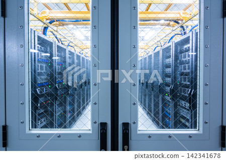 Rows of server racks in a modern data center viewed through a secured doorway Rows of server racks in a modern data center viewed through a secured doorway 142341678