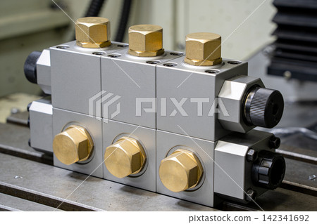 Precision engineered hydraulic manifold block with brass fittings and control knobs Precision engineered hydraulic manifold block with brass fittings and control knobs 142341692