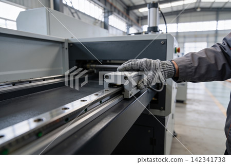 Industrial worker's gloved hand operating precision linear motion guide system Industrial worker's gloved hand operating precision linear motion guide system 142341738