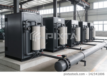 Industrial air filtration units lined up in a factory setting with large pipes Industrial air filtration units lined up in a factory setting with large pipes 142341806