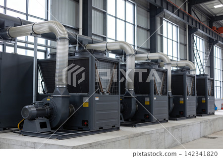 Industrial HVAC units with large flexible ducts in a modern factory setting Industrial HVAC units with large flexible ducts in a modern factory setting 142341820
