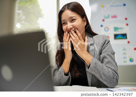 Successful Businesswoman Reacting with Surprise During Laptop Meeting Successful Businesswoman Reacting with Surprise During Laptop Meeting 142342397