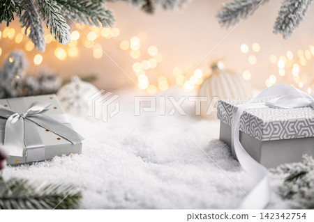 Silver and White Gift Boxes on Snow with Holiday Lights Silver and White Gift Boxes on Snow with Holiday Lights 142342754