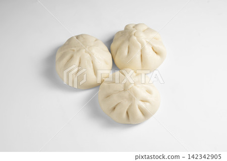 Soft steamed bao buns with pleated tops on white background 142342905