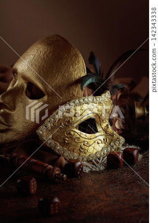 Golden vintage carnival masks with old wooden dices. Golden vintage carnival masks with old wooden dices. 142343338