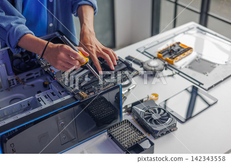 Computer engineer repairing computer motherboard and hardware components. Computer engineer repairing computer motherboard and hardware components. 142343558