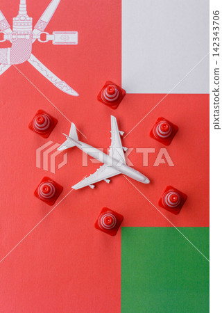 A mock up of airplane surrounded by no fly signs on a Omani flag as a background A mock up of airplane surrounded by no fly signs on a Omani flag as a background 142343706