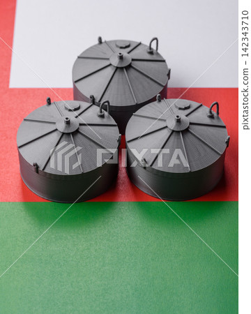 Liquefied gas storage tanks set against the Omani flag, representing the concept of supply Liquefied gas storage tanks set against the Omani flag, representing the concept of supply 142343710