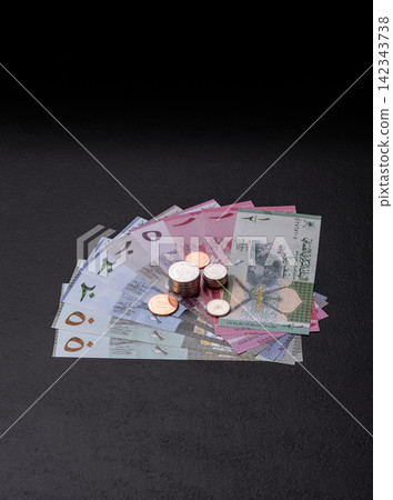 Oman, omani paper money, rial or riyal banknotes and coins as currency for exchange. Omani money Oman, omani paper money, rial or riyal banknotes and coins as currency for exchange. Omani money 142343738