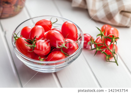 Fresh Cherry Tomatoes in Glass Bowl With Kitchen Towel Rustic Still Life for Cooking Fresh Cherry Tomatoes in Glass Bowl With Kitchen Towel Rustic Still Life for Cooking 142343754