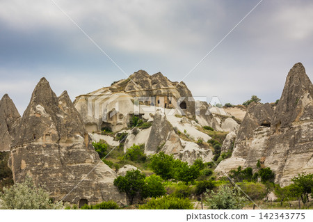 Amazing Volcanic rock formations known as Love Valley or Fairy Chimneys in Cappadocia, Turkey. Mushroom Valley one of attractions in Goreme National Park, Turkey. Mountains with rooms inside Amazing Volcanic rock formations known as Love Valley or Fairy Chimneys in Cappadocia, Turkey. Mushroom Valley one of attractions in Goreme National Park, Turkey. Mountains with rooms inside 142343775