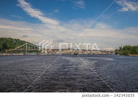 View from a passenger river ship in the middle of the river to a bridge. River pleasure boat in the middle of the river.Walks on holidays and weekends View from a passenger river ship in the middle of the river to a bridge. River pleasure boat in the middle of the river.Walks on holidays and weekends 142343835