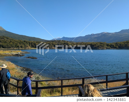 Ushuaia, Tierra del Fuego, Argentina - March 7, 2026: Scenic Lago Acigami viewpoint with visitors. Ushuaia, Tierra del Fuego, Argentina - March 7, 2026: Scenic Lago Acigami viewpoint with visitors. 142343881