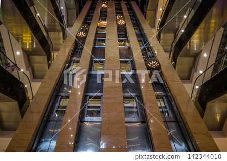 UKRAINE. KYIV - 13 JUNE 2021. View of moving elevators, walls, and balconies of the contemporary business center that can be used as background UKRAINE. KYIV - 13 JUNE 2021. View of moving elevators, walls, and balconies of the contemporary business center that can be used as background 142344010