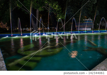 Colorful water fountains. Beautiful laser and fountain show. Large multi colored decorative dancing water jet led light fountain show at night. Colorful water fountains. Beautiful laser and fountain show. Large multi colored decorative dancing water jet led light fountain show at night. 142344061