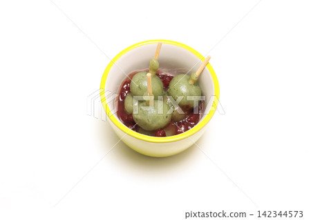Mugwort dumplings and red bean paste in a green bowl Mugwort dumplings and red bean paste in a green bowl 142344573