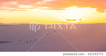 Snowscape of Tottori Sand Dunes bathed in the orange glow of the setting sun Snowscape of Tottori Sand Dunes bathed in the orange glow of the setting sun 142345772