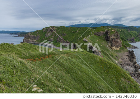 A dynamic panoramic view of the lush green ridge of Cape Kamui in Shakotan Town, Hokkaido, Japan. A dynamic panoramic view of the lush green ridge of Cape Kamui in Shakotan Town, Hokkaido, Japan. 142346330