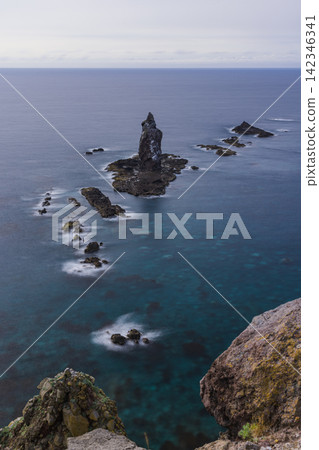 Kamui Rock, a mysterious and strangely shaped rock formation, stands quietly offshore from Cape Kamui in Shakotan Town, Hokkaido, Japan. Kamui Rock, a mysterious and strangely shaped rock formation, stands quietly offshore from Cape Kamui in Shakotan Town, Hokkaido, Japan. 142346341