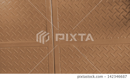 Industrial metal surface with a brown diamond-patterned steel plate texture. Industrial metal surface with a brown diamond-patterned steel plate texture. 142346687