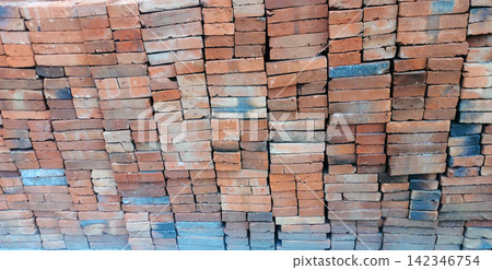 A stack of red clay bricks A stack of red clay bricks 142346754