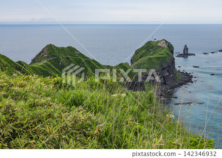 Japan, Hokkaido, Shakotan Town: The beautiful ridge leading to the tip of Cape Kamui, the Cape Kamui Lighthouse, and the spectacular view of Kamui Rock. Japan, Hokkaido, Shakotan Town: The beautiful ridge leading to the tip of Cape Kamui, the Cape Kamui Lighthouse, and the spectacular view of Kamui Rock. 142346932