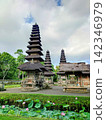 A traditional multi-tiered pagoda and a beautiful lotus pond at Taman Ayun Temple, a World Heritage Site in Bali. 142346979