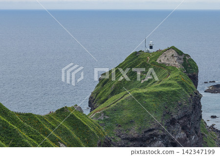 Japan - The Kamui Cape Lighthouse, perched on the rugged cliffs of Cape Kamui in Shakotan Town, Hokkaido, and the vast Sea of Japan. Japan - The Kamui Cape Lighthouse, perched on the rugged cliffs of Cape Kamui in Shakotan Town, Hokkaido, and the vast Sea of Japan. 142347199